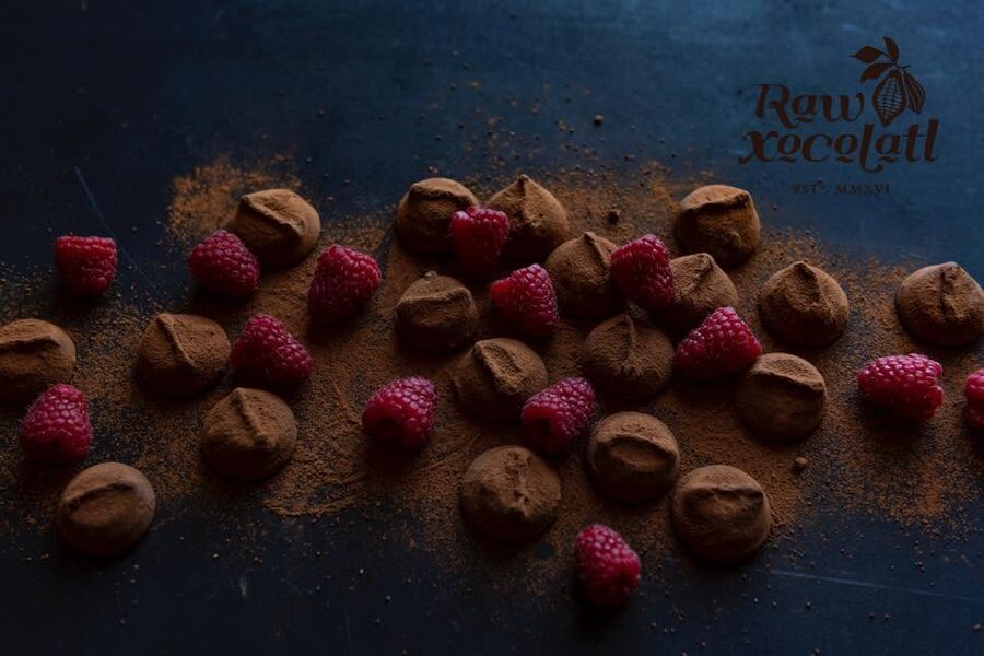 Cocoa-dusted chocolates with raspberries